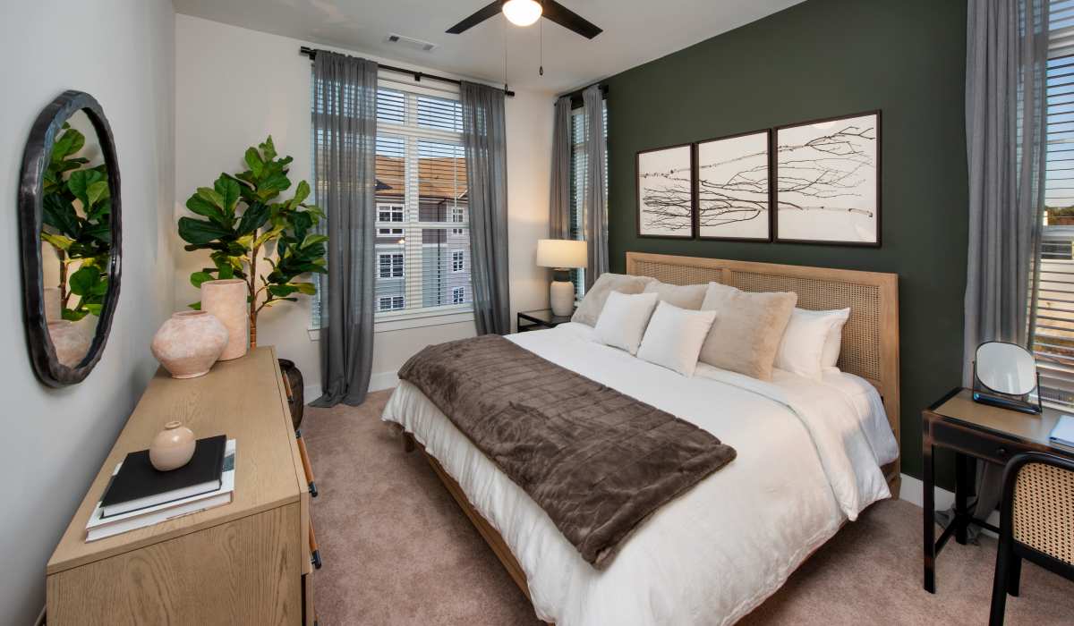Bedroom with a large bed and Expansive Windows at The Row at Barrett, Kennesaw, Georgia