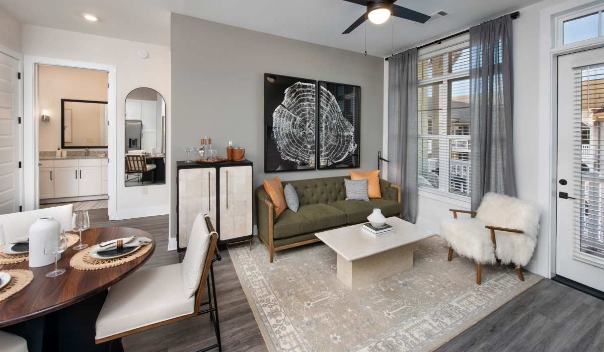 Living room with couch and ceiling fan at The Row at Barrett, Kennesaw, Georgia