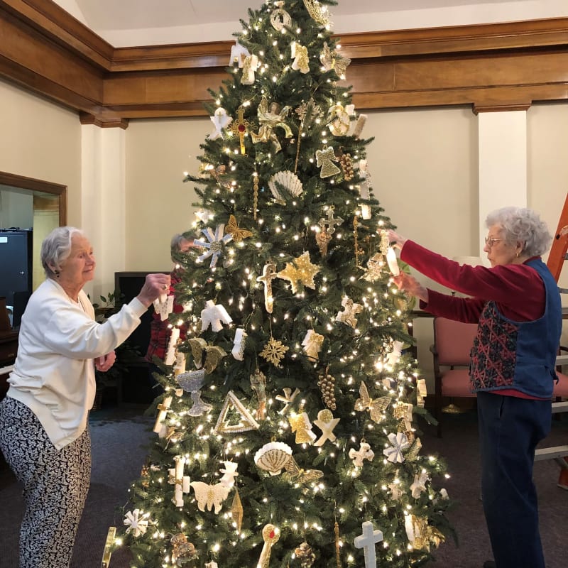 residents decorating a christmas tree at a Presbyterian Communities of South Carolina community