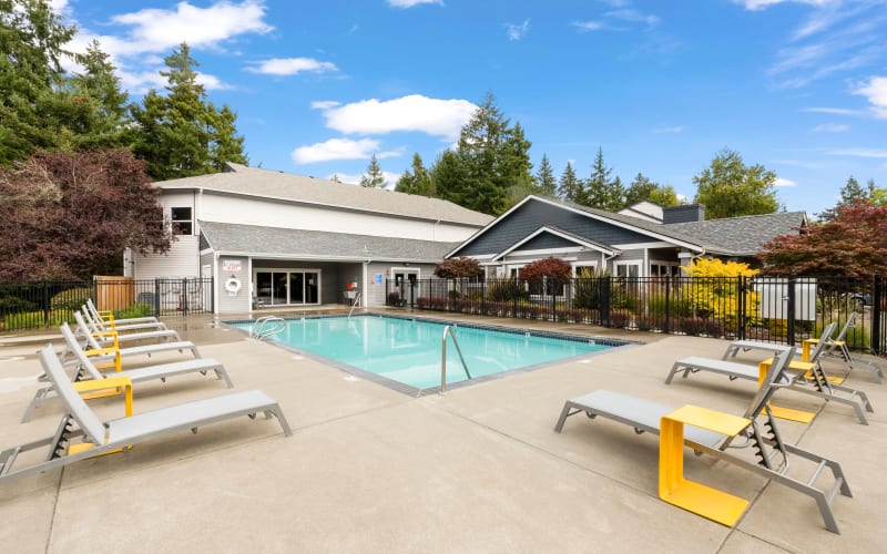 Seating near the swimming pool on a sunny day at Cascade Ridge in Silverdale, Washington