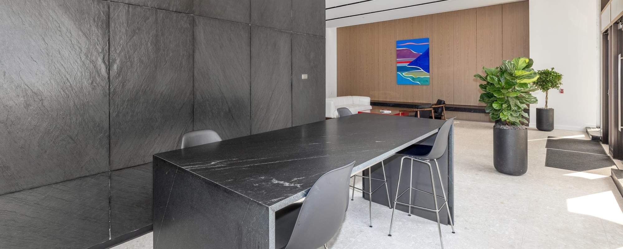 Resident golf simulator room with lounge seating and high-top table at Residences at 111 Lyon in Grand Rapids, Michigan