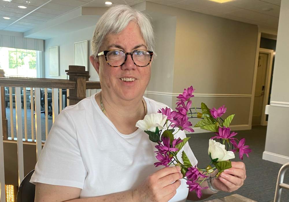 Resident with flowers at Merrill Gardens at West Chester in West Chester, Pennsylvania