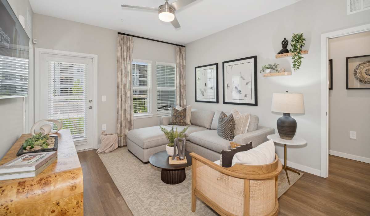 Furnished apartment living room with wood-style flooring at Savelle Nona West in Orlando, Florida