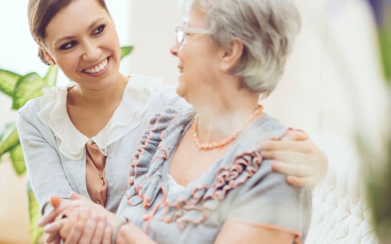 Resident talking with a younger family member at MBK Senior Living in Irvine, California