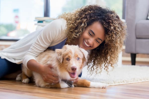 A resident playing with a dog at Commons at Briarwood Park in Brookhaven, Georgia