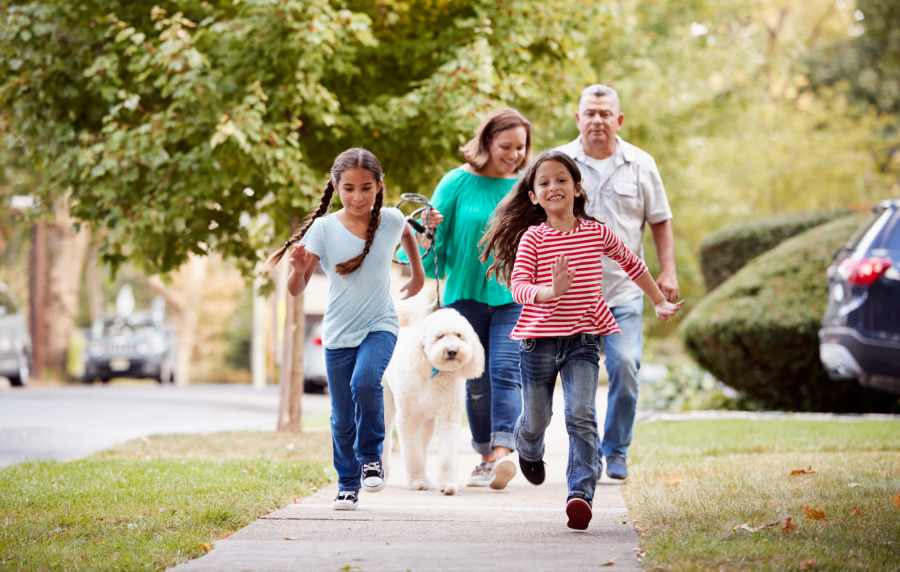 Family walking with dog near Balcones Trails in Kyle, Texas