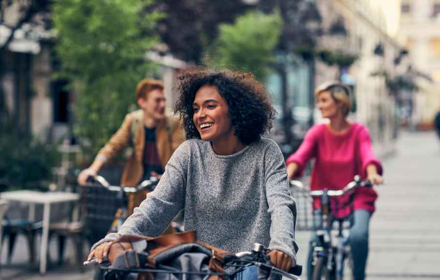 Women cycling at Harbor Cove Apartments in Foster City, California,