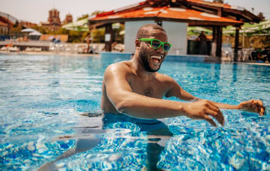 Man enjoying resort-style pool at Oak Creek in New Braunfels, Texas