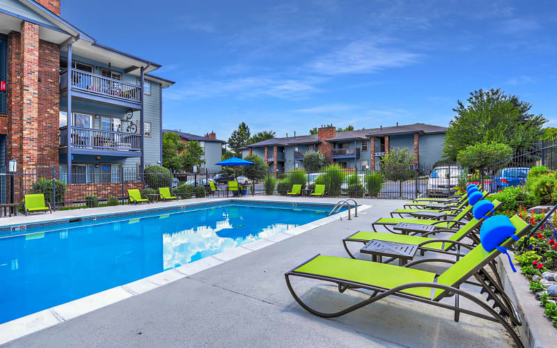 Covered seating at the barbecue area overlooking the pool at Arapahoe Club Apartments in Denver, Colorado