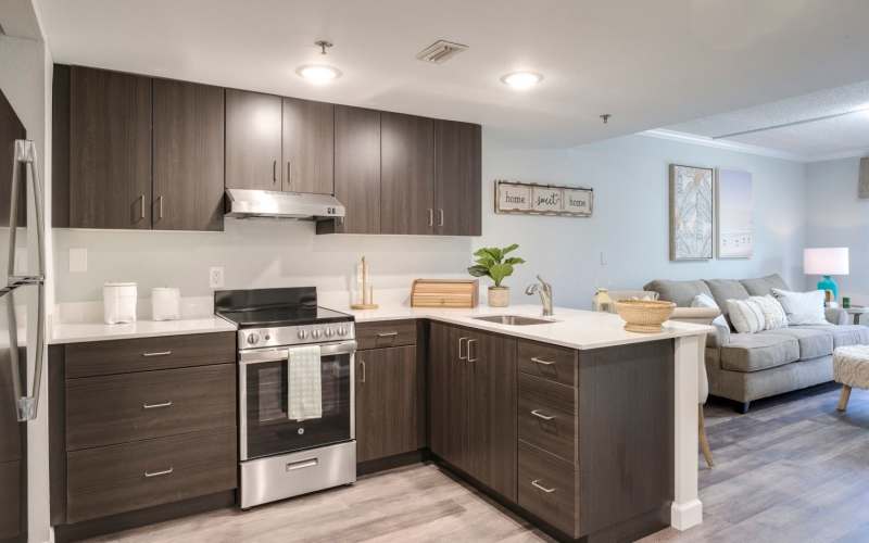 Modern kitchen with built-in refrigerator, sink, and cabinet at Grand Villa of Port Charlotte in Port Charlotte, Florida