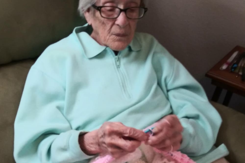 Resident knitting at Arlington Place of Red Oak in Red Oak, Iowa