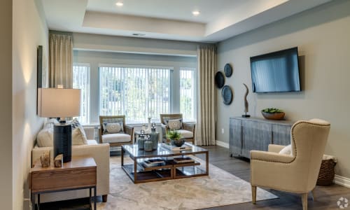 Spacious living room with large windows at Encore at Deerhill in Clarkston, Michigan