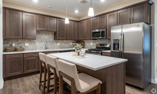 Model kitchen with stainless-steel appliances at Encore at Deerhill in Clarkston, Michigan