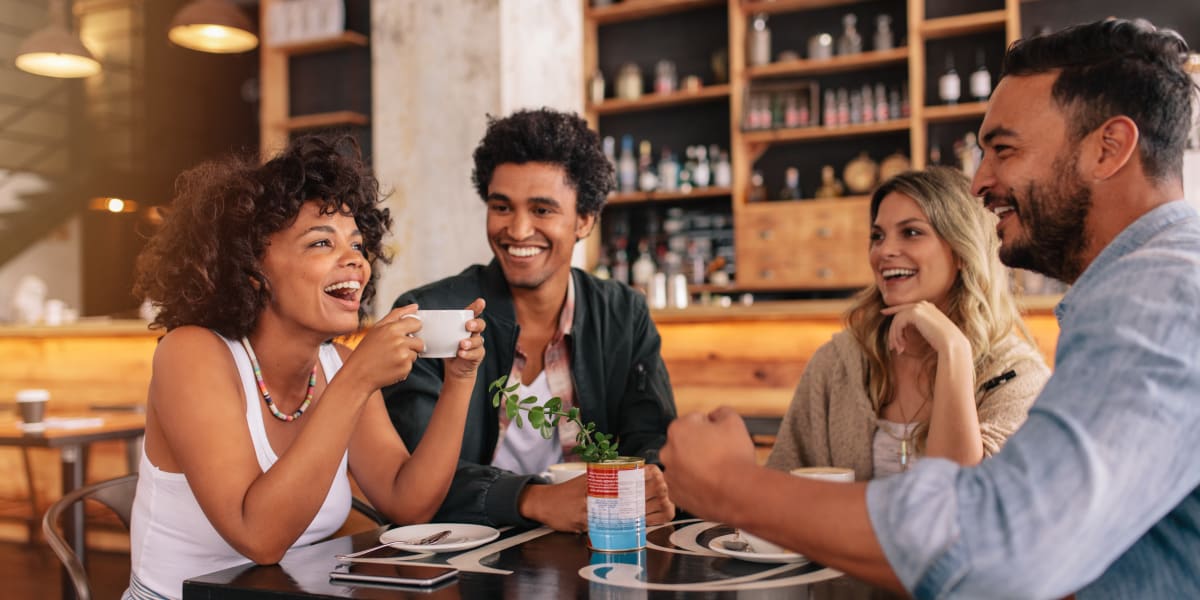 Friends enjoying coffee at local café near Marquis at Great Hills in Austin, Texas