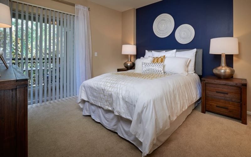 Master bedroom with plush carpeting at Legend Oaks Apartments in Aurora,