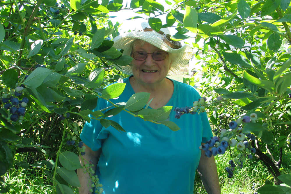 Woman walking outside through some brush at Quail Park at Shannon Ranch in Visalia, California