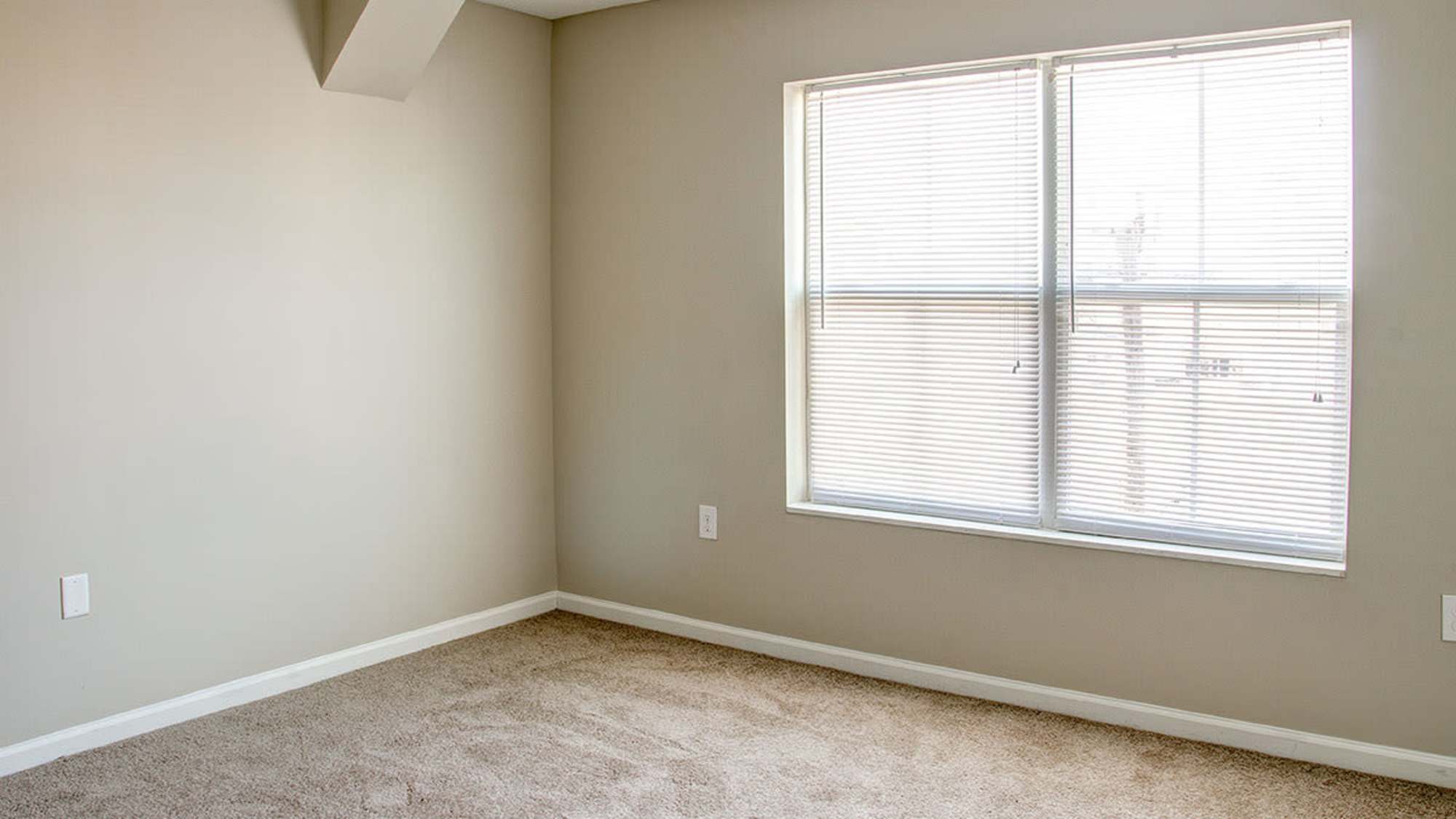 Bedroom with carpet flooring at Brennan Pointe II in Newport News. VA