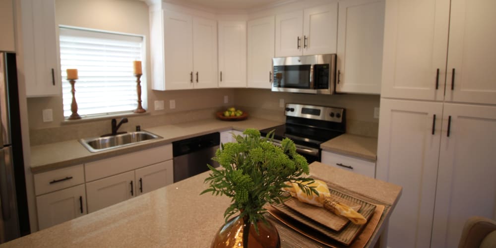 Fully equipped kitchen with white Shaker cabinetry and stainless-steel appliances at Ramblewood Apartments in Fremont, California