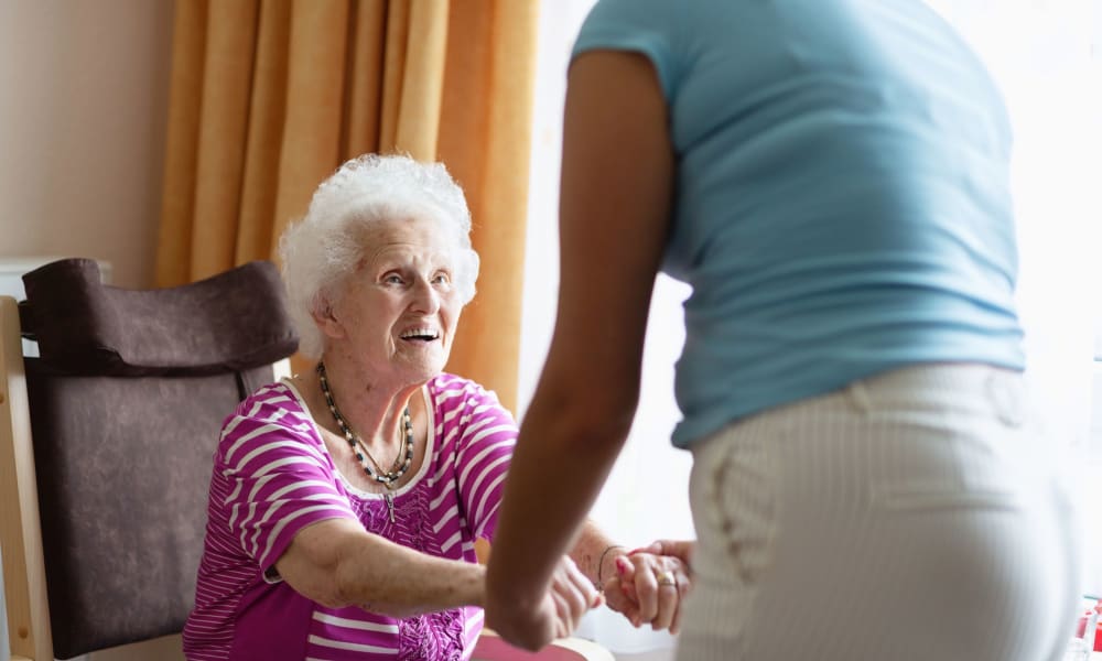 Resident being helped out of a chair at Randall Residence of Sterling Heights in Sterling Heights, Michigan