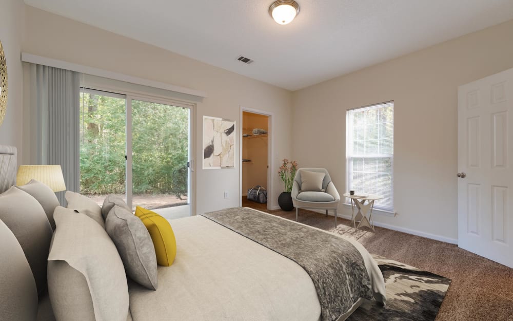 Model bedroom with walk-in closet at Forest Oaks Apartment Homes in Rock Hill, South Carolina