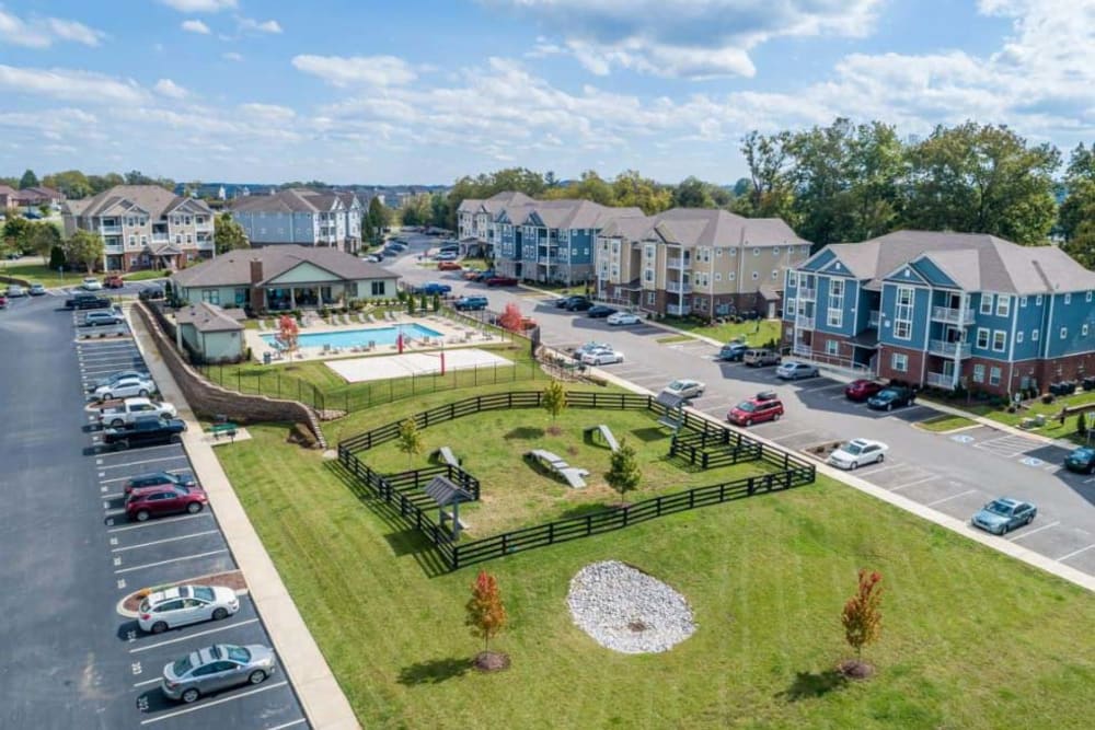 Low aerial view of the community's dog park and swimming pool area at The Retreat at Arden Village Apartments in Columbia, Tennessee