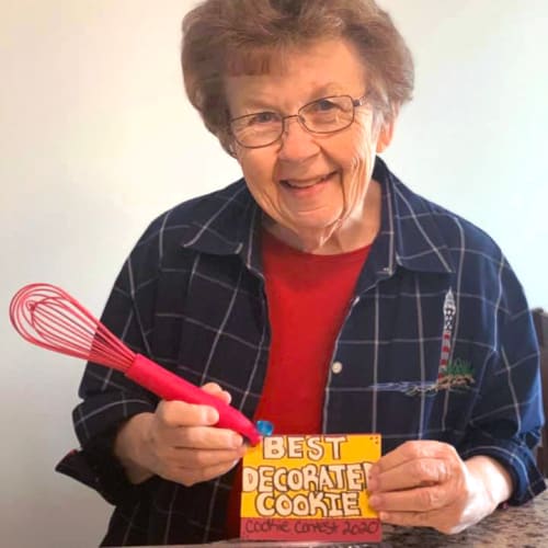 Resident with her award for best decorated cookie at Oxford Villa Active Senior Apartments in Wichita, Kansas