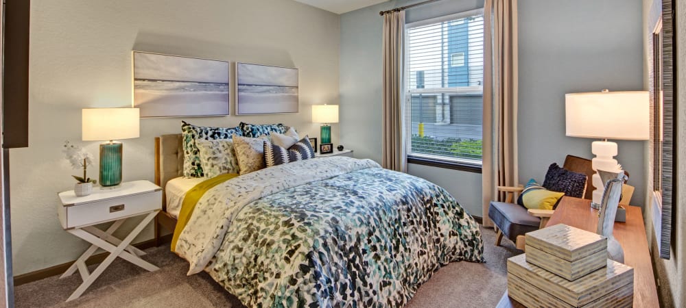 Well-lit model bedroom at The Courtney at Lake Shadow in Orlando, Florida