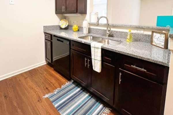 Kitchen with wooden cabinets and wood-style flooring at Catawba in Belmont, North Carolina