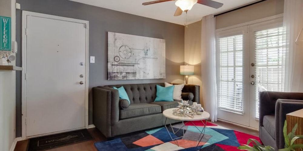 Living room with a cute area rug and ceiling fan at Vantage Point in Houston, Texas