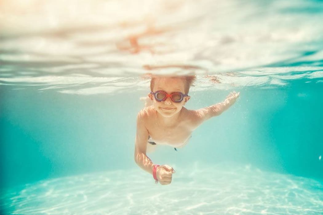 Child swimming in one of the beautiful pools at Aliro in North Miami, Florida