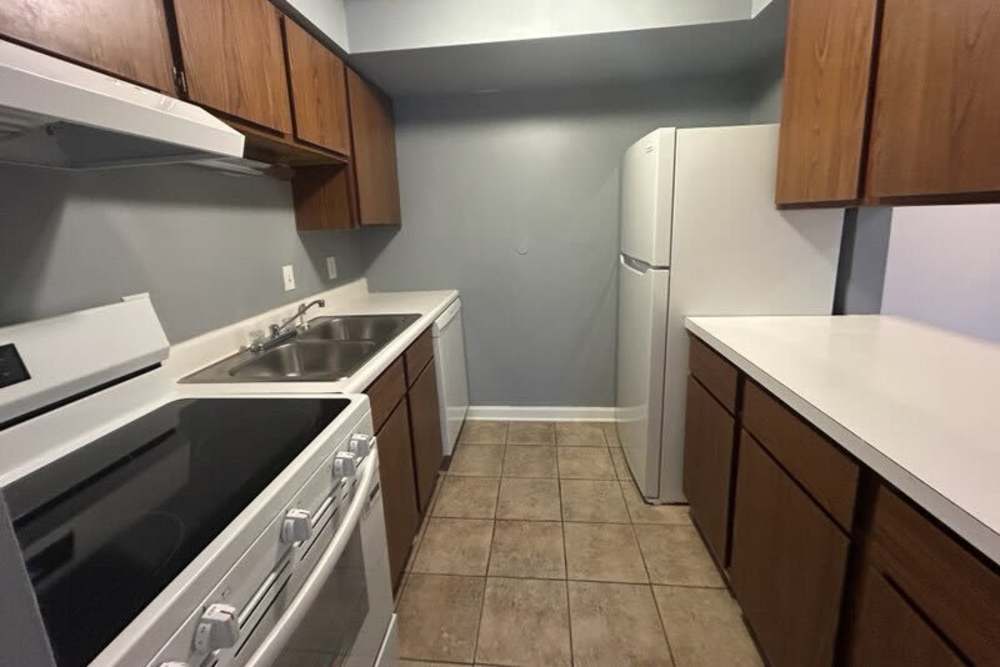 Kitchen with range and wooden cabinets at Brookside Commons in Meadville, Pennsylvania