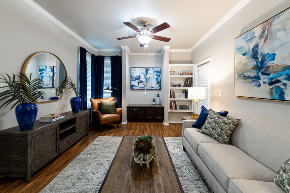 Modern style decorated living room with built-in shelves at Marquis at Bellaire Ranch in Fort Worth, Texas