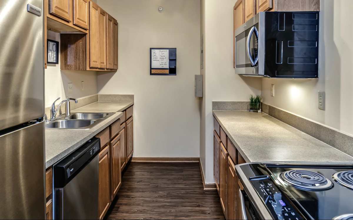 Kitchen with refrigerator, dishwasher and oven at The Falgrove Apartments in Omaha, Nebraska