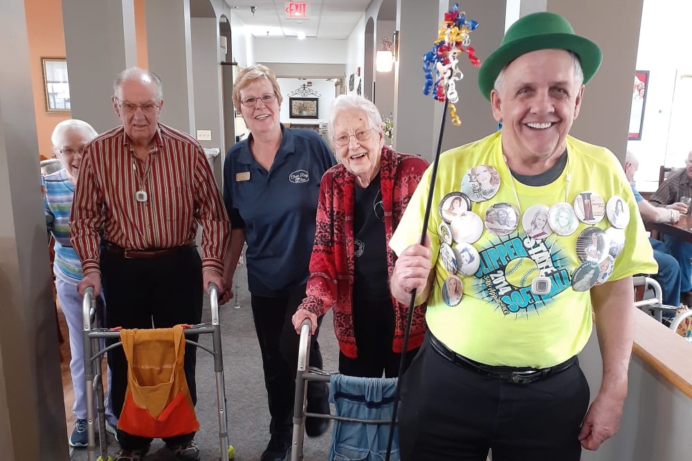 Resident in festive hat leads holiday parade at Clover Ridge Place in Maquoketa, Iowa.