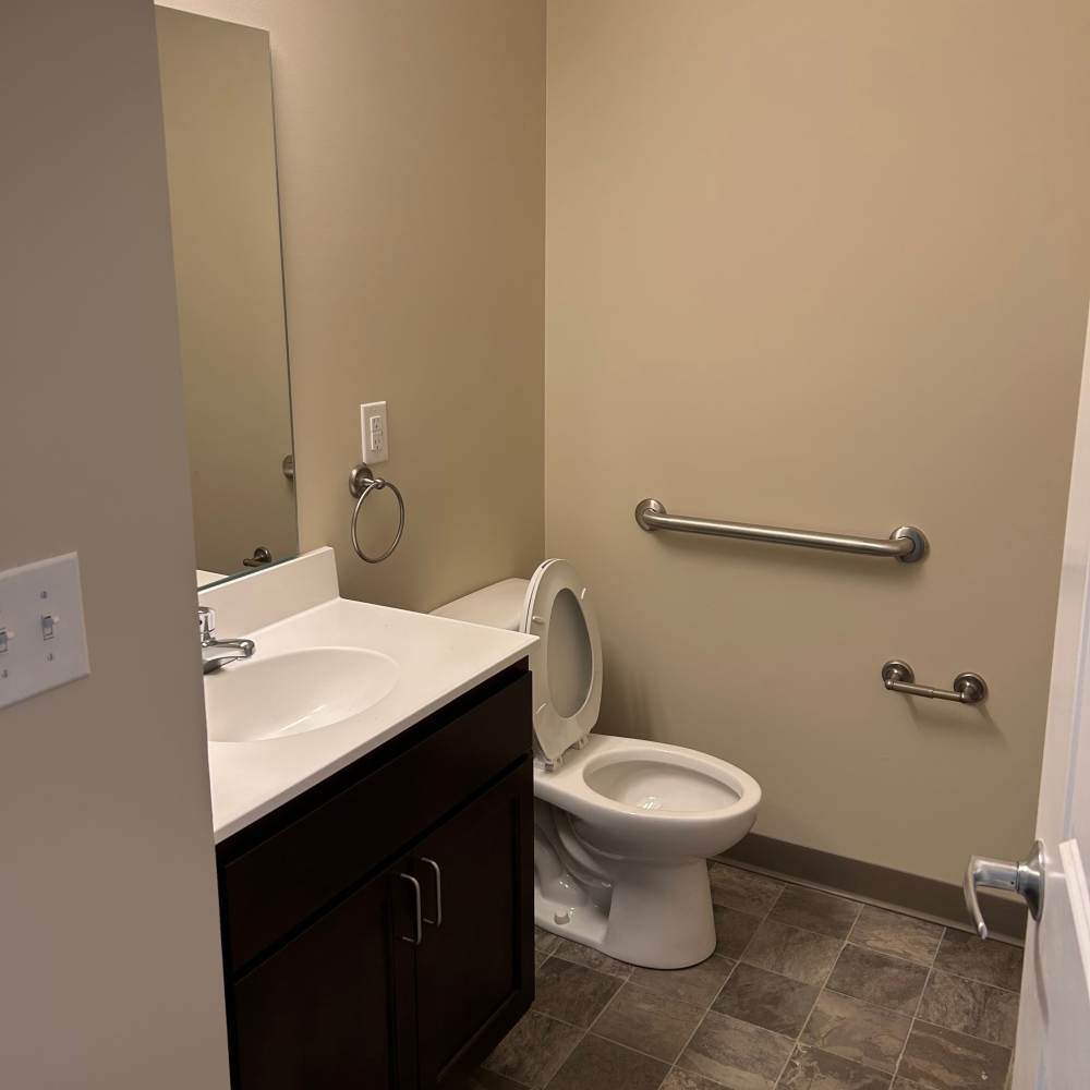 Bathroom with minimal lighting at Grandview South Homes in Pittsburgh, Pennsylvania