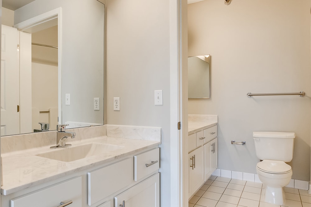 A lovely bathroom with white cabinetry at Provence Apartments in Burnsville, Minnesota