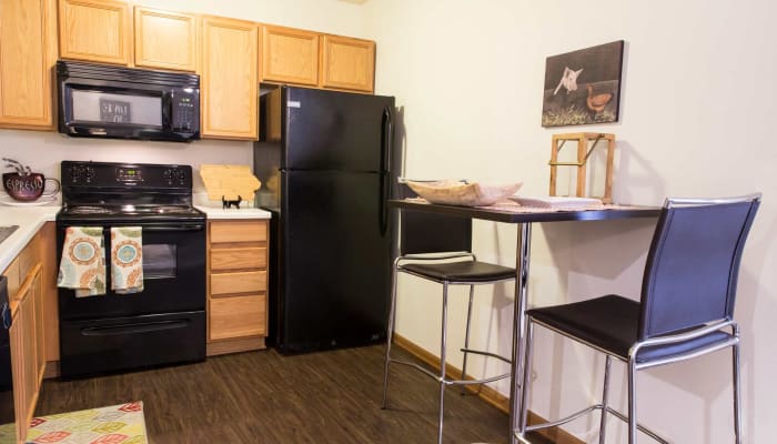 A kitchen with a fridge and microwave at Prairie Reserve in Cedar Rapids, Iowa