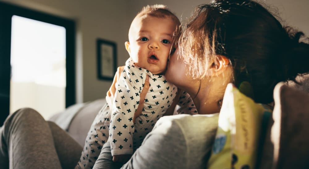 A mother holds her baby at Ellet Park Gardens in Akron, Ohio