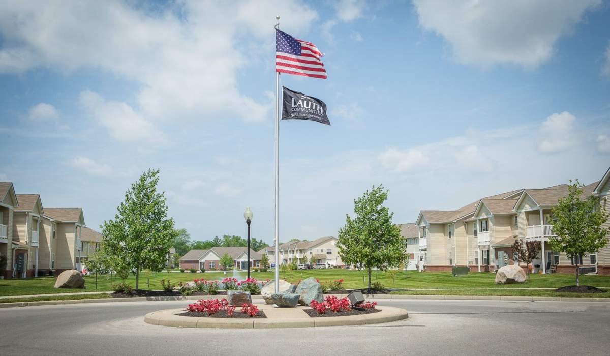 Property exterior with a property flag hoisted at Bluestone in Greenfield,Indiana