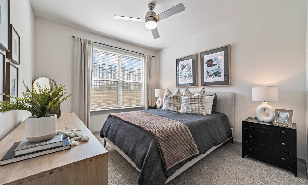 Apartment bedroom with cozy bed at Main and Mill in Lewisville,Texas