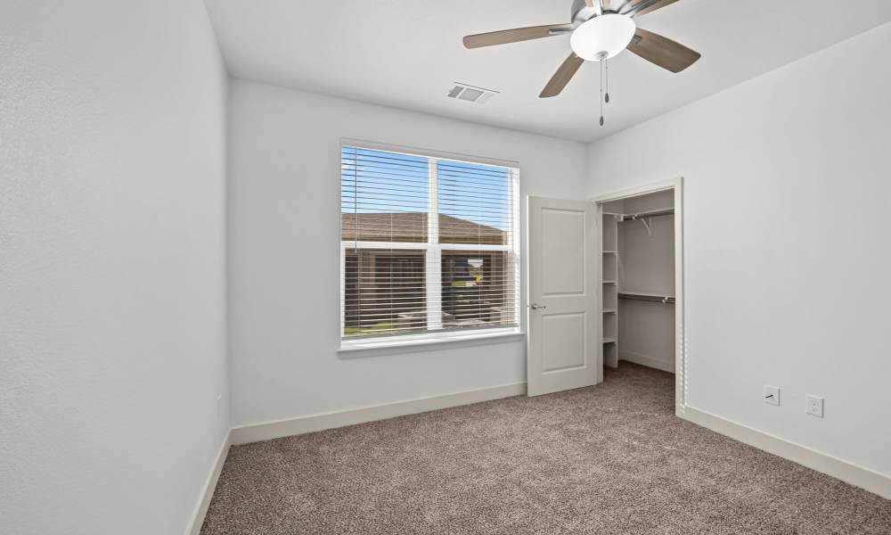 Bedroom with plush carpeting at Brook Hollow in Wichita Falls, Texas
