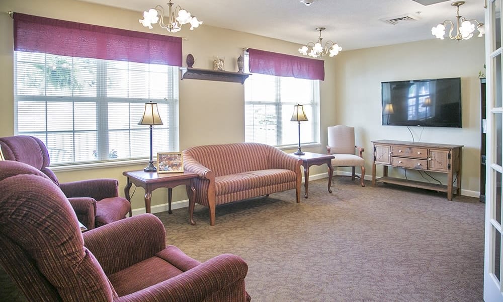 Resident community area with TV and couches at Randall Residence of Wheelersburg in Wheelersburg, Ohio