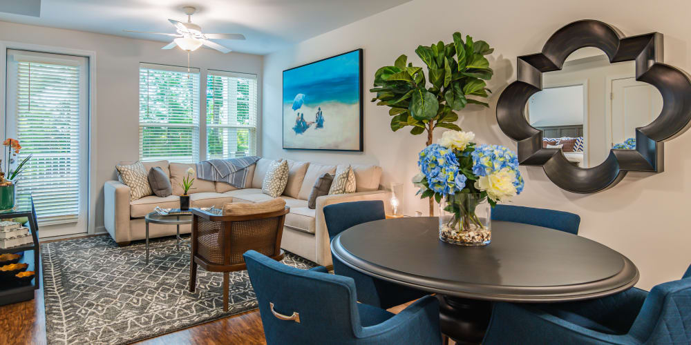 Living area of a model apartment with a private balcony at Glenmoor Oaks in Moseley, Virginia