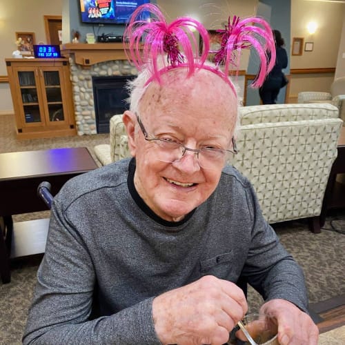 Resident wearing a pink frilly headpiece at Glen Carr House Memory Care in Derby, Kansas