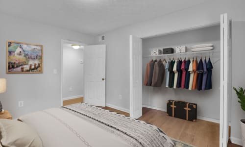 An apartment bedroom with an open closet at Residence at Riverside in Austell, Georgia