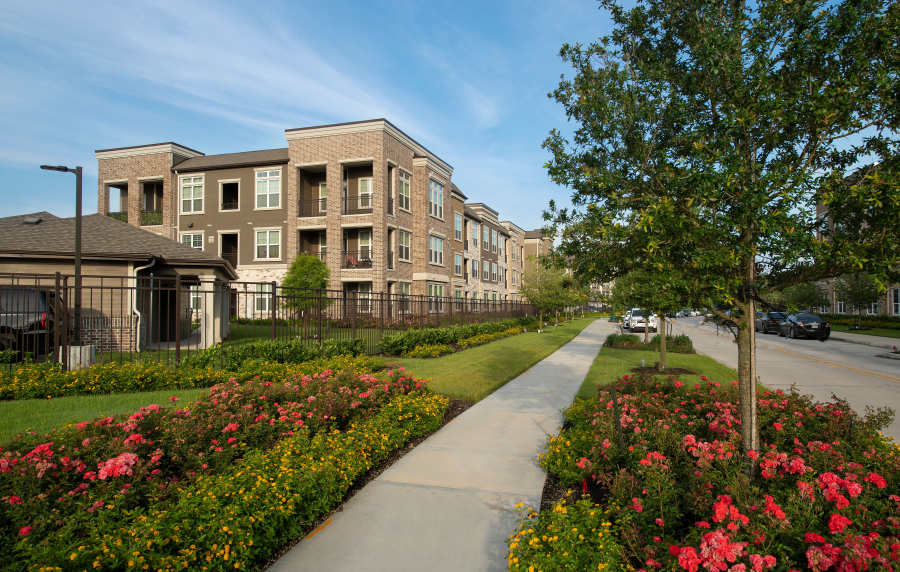 Exterior view of the community with greenery at Orleans at Fannin Station in Houston, Texas