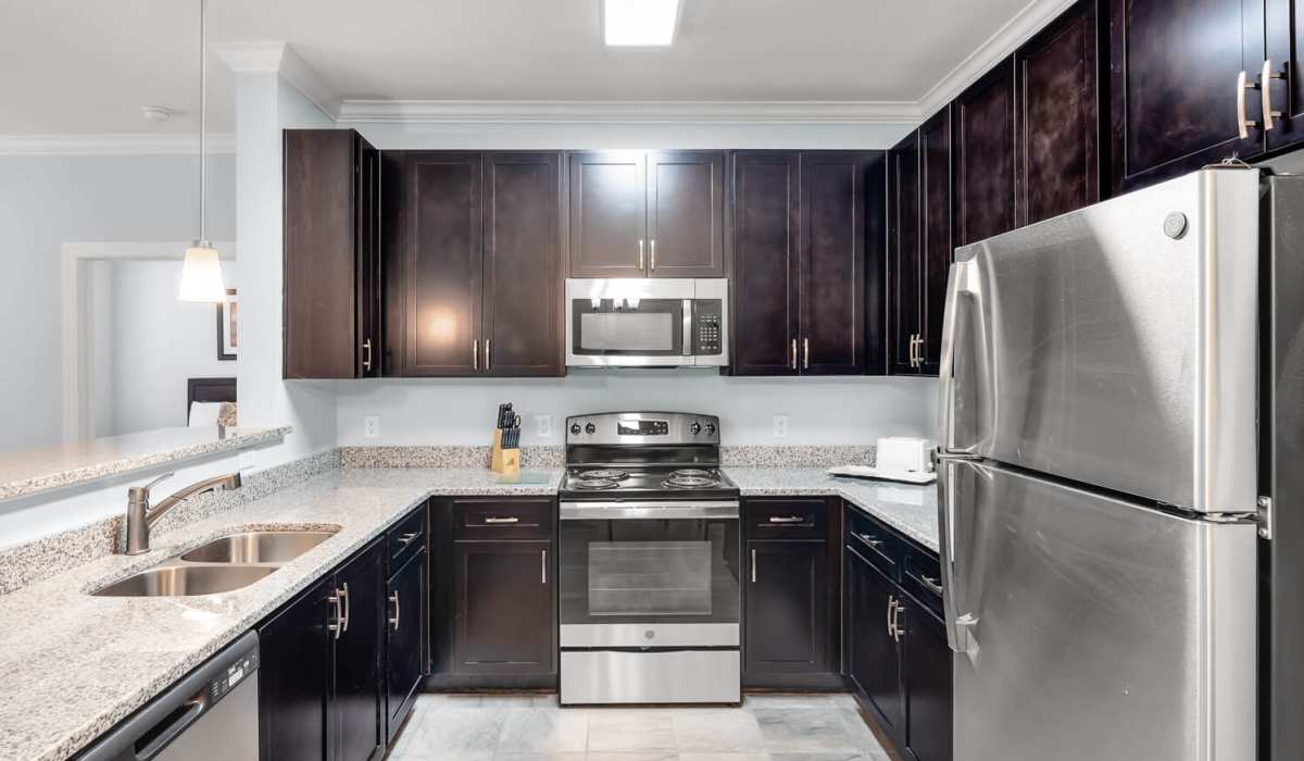 Kitchen with refrigerator and wood cabinetry at Palisades of Charleston in Johns Island. SC