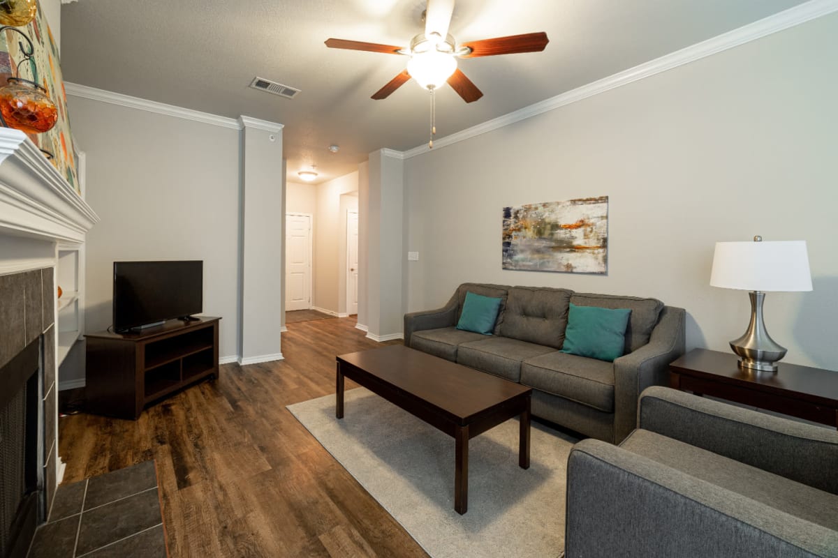 Bright living room with fireplace at Marquis at Bellaire Ranch in Fort Worth, Texas