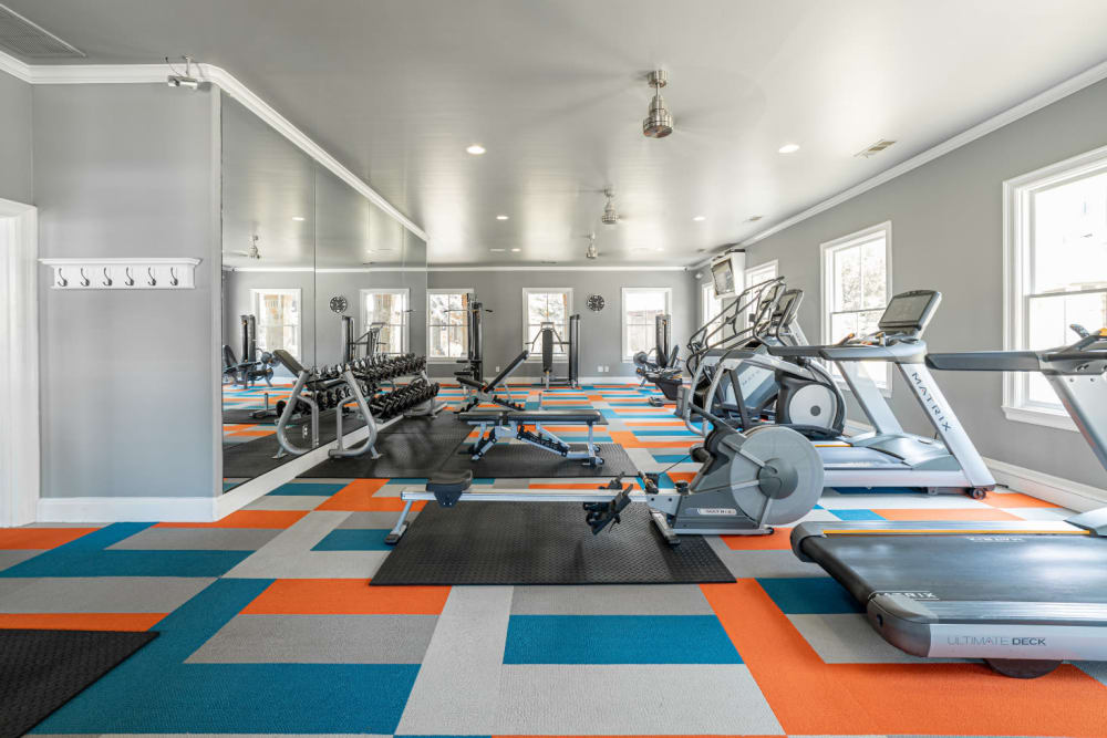Large fitness room with cardio machines and free weights at Marquis at Bellaire Ranch in Fort Worth, Texas