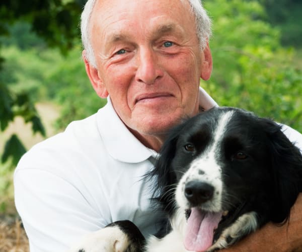 Resident enjoying time with his dog at Arbor Hills in Lakeland, Florida